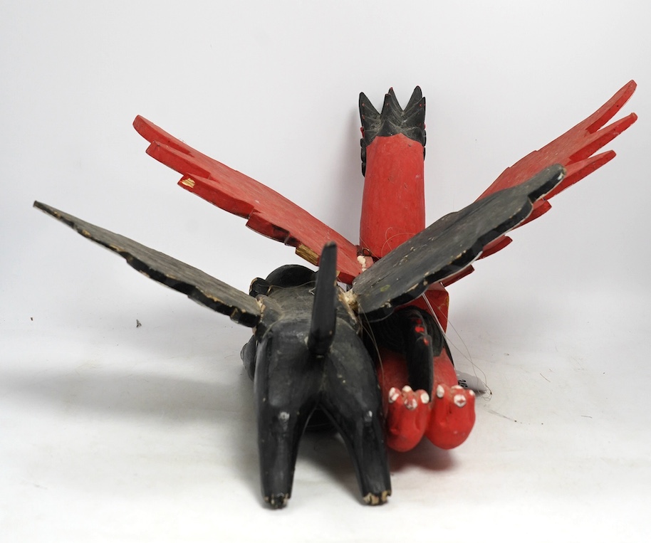 Two Balinese carved and painted wood winged creatures, largest 44cm long. Condition - fair